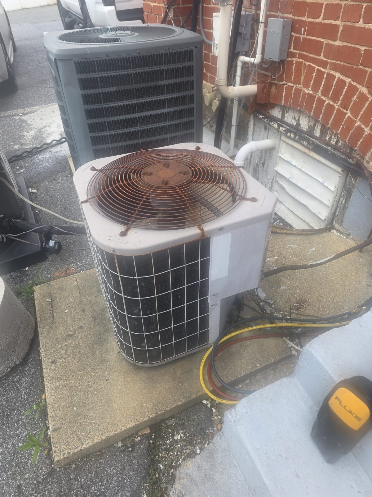 Outdoor AC condenser units at a residential property